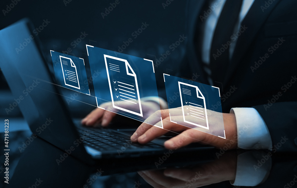 Naklejka premium Businessman working on laptop with virtual screen. Process automation to efficiently manage files.Online documentation database and document management system concept.