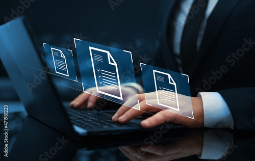 Businessman working on laptop with virtual screen. Process automation to efficiently manage files.Online documentation database and document management system concept.