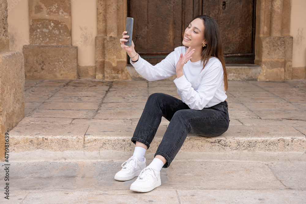 woman sitting making date video call with mobile phone