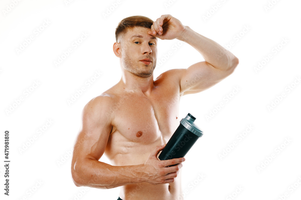 a man an athlete with a pumped-up body drinks from a bottle a man an athlete with a pumped-up body drinks from a bottle