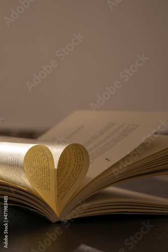 Book with heart in the middle illuminated with natural light