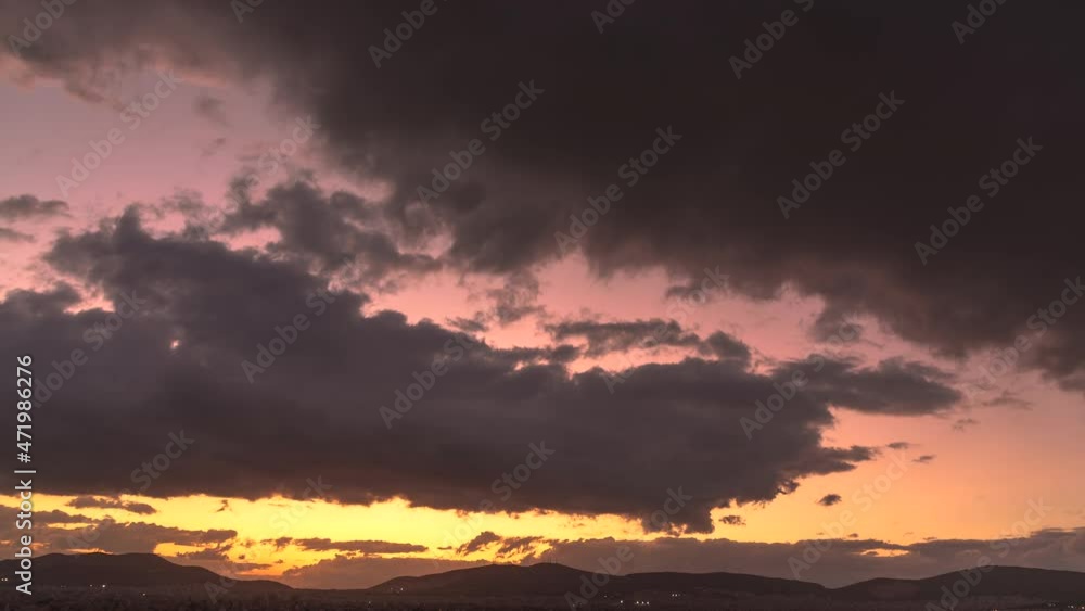 Clouds forming in sky rolling through air during colorful dreamy sunset, timelapse Clouds forming in sky rolling through air during colorful dreamy sunset, timelapse