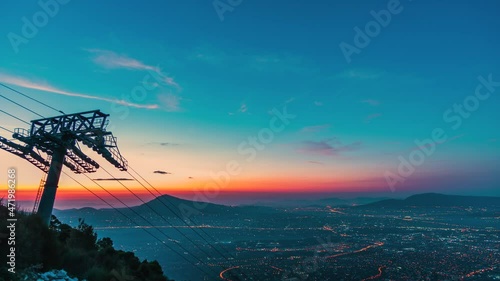 Magical sunrise above Athens with Parnitha Funitel cable tower on slope, timelapse photo