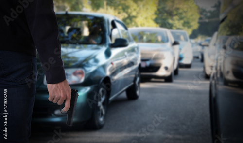 Fotografie Man with gun near cars outdoors, closeup