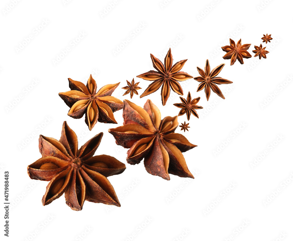 Dry aromatic anise stars falling on white background Dry aromatic anise stars falling on white background