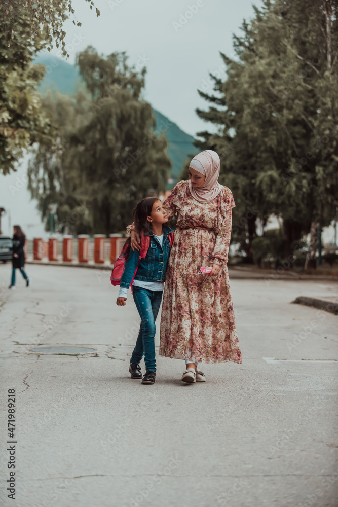 a Muslim mother returns from school with her daughter. Selective focus a Muslim mother returns from school with her daughter. Selective focus