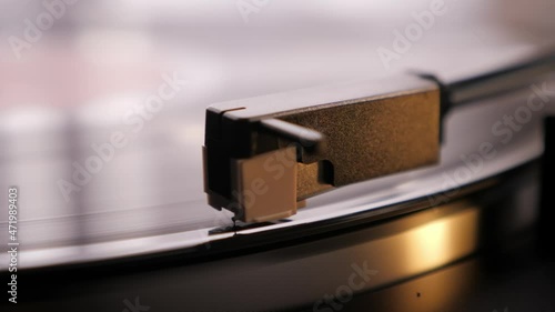 Vinyl record player needle, close up. Music concept. Vintage retro turntable photo