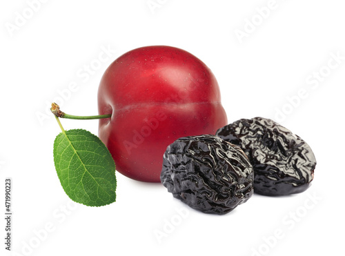 Delicious fresh ripe plum and sweet dried prunes on white background