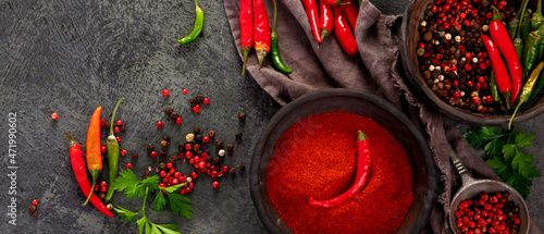 Photography Red chili or chilli cayenne pepper and peppercorns on dark background