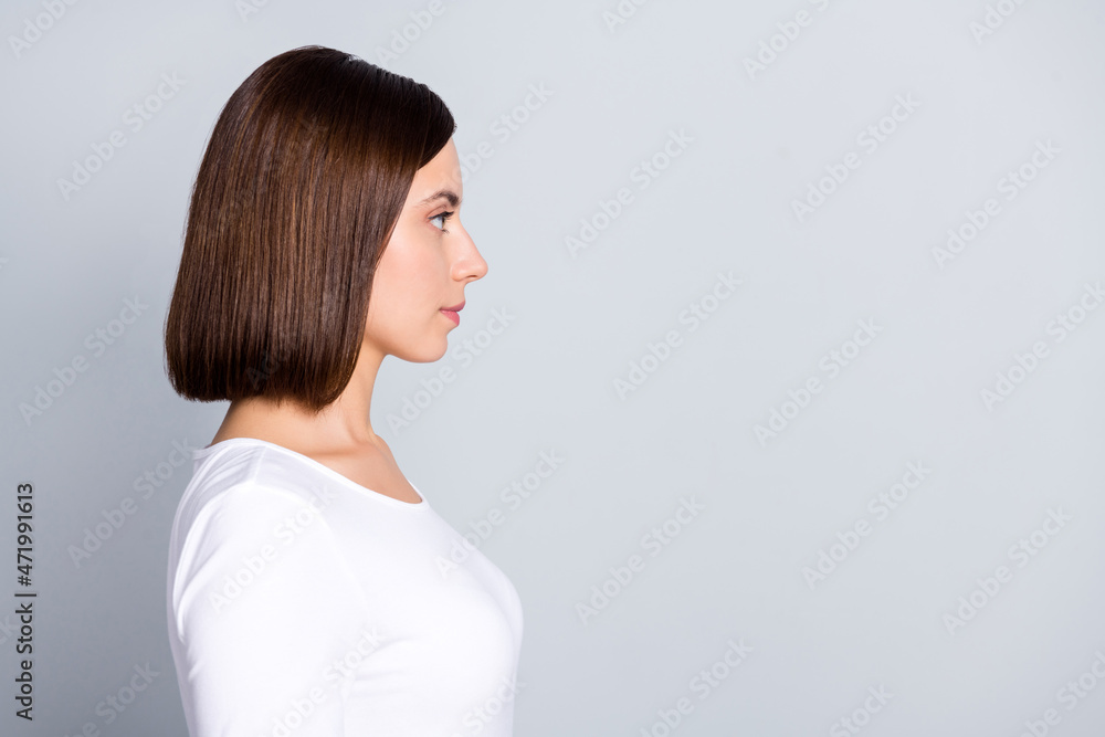 Profile photo of strict brunette millennial lady look empty space wear white pullover isolated on grey color background Profile photo of strict brunette millennial lady look empty space wear white pullover isolated on grey color background