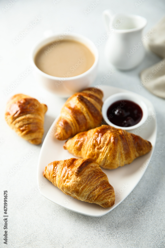 Traditional homemade French croissants with coffee and jam