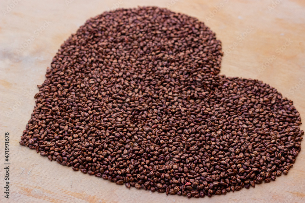 Grape seeds laid out in the shape of a heart. Cardiovascular care symbol