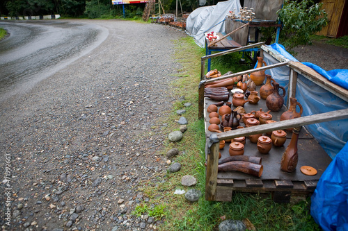 A variety of clay cooking utensils are sold by the side of the road. photo