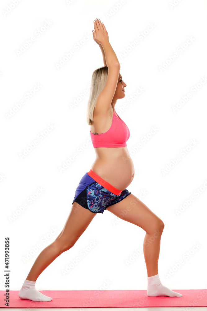Portrait of a beautiful young pregnant woman doing exercises in the studio Portrait of a beautiful young pregnant woman doing exercises in the studio