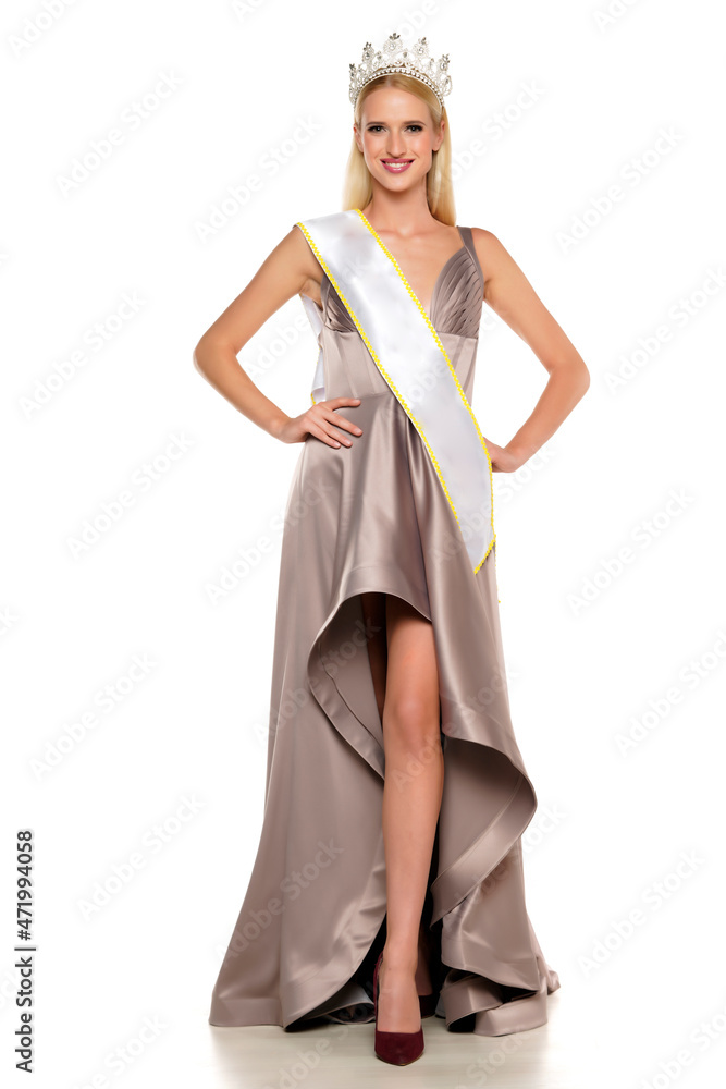 Naklejka premium young woman with a crown , evening dress and the winning ribon
