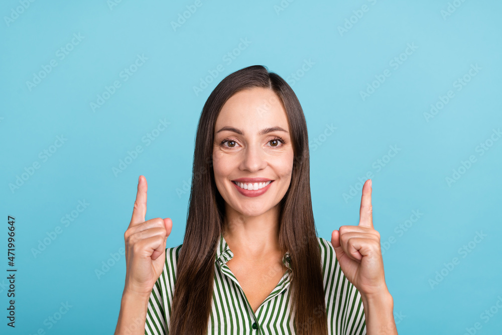 Photo of lovely mature woman indicate fingers empty space discount advise ads isolated over blue color background Photo of lovely mature woman indicate fingers empty space discount advise ads isolated over blue color background