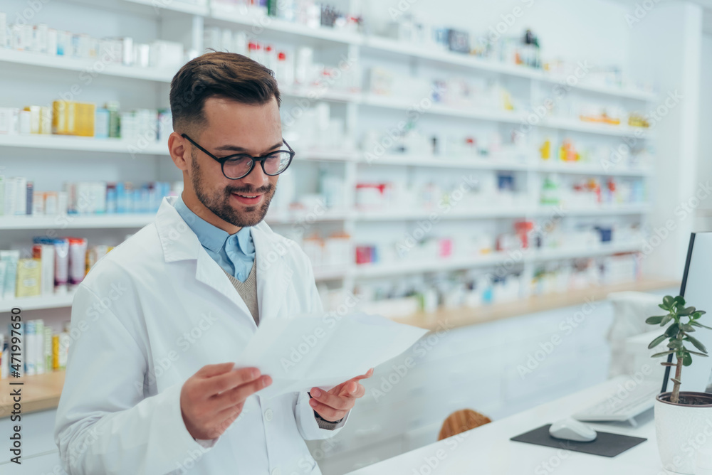 Portrait of a handsome pharmacist working in a pharmacy Portrait of a handsome pharmacist working in a pharmacy
