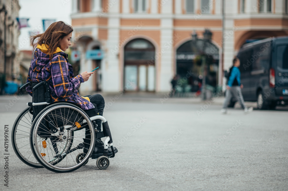 Woman with disability using a smartphone while out in the city