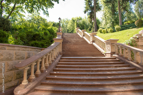 Park landscape. Beautiful exquisite stone staircase in the park