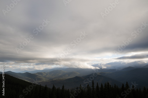 Dark dramatic clouds over mountains, mountain landscape, autumn morning view of mountain ranges
