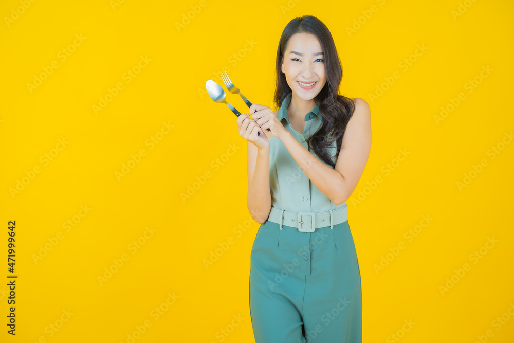 Portrait beautiful young asian woman smile with spoon and fork Portrait beautiful young asian woman smile with spoon and fork