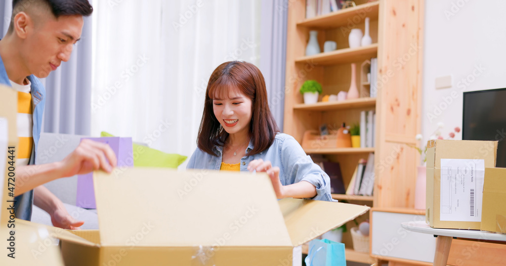 couple open delivery boxes couple open delivery boxes