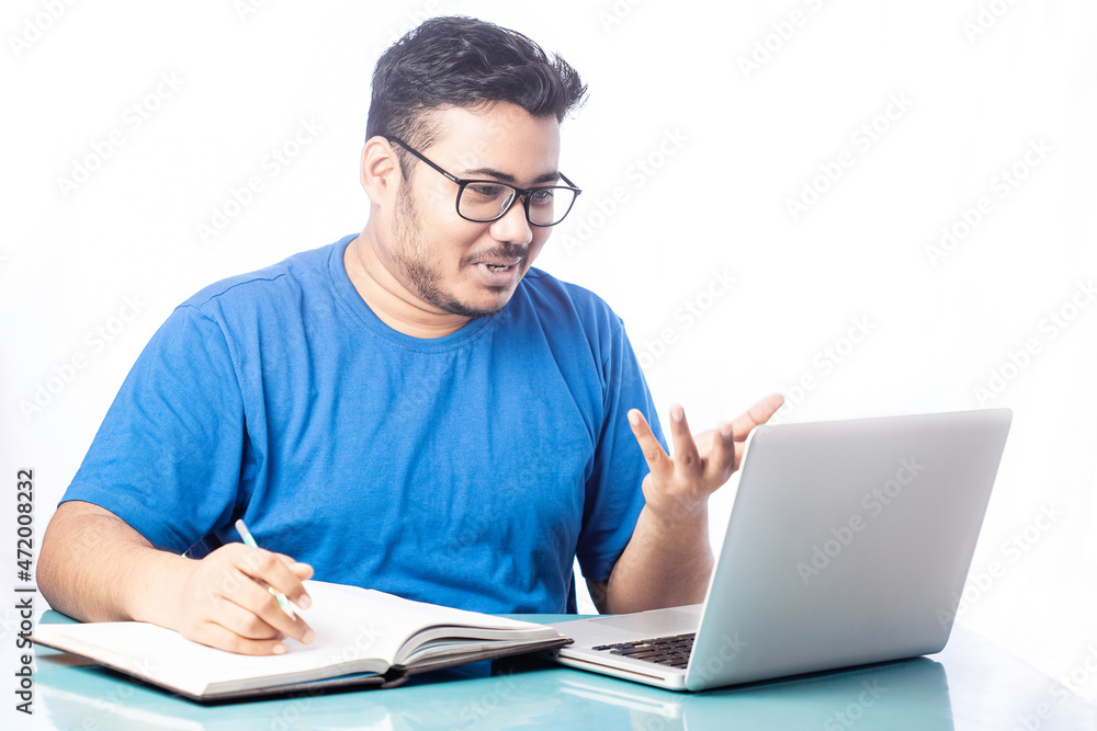 young man smiling and talking with someone on video chat using laptop young man smiling and talking with someone on video chat using laptop