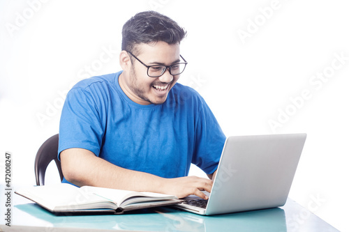 cheerful student studying online course on laptop © Dharma