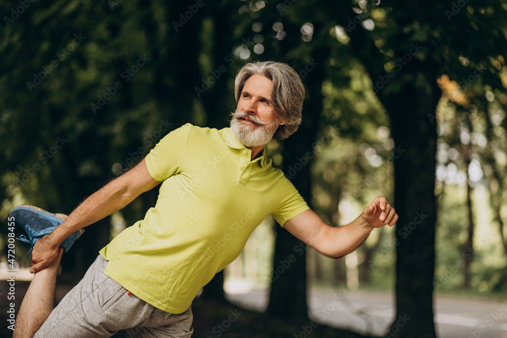 Middle aged man jogging in forest Middle aged man jogging in forest