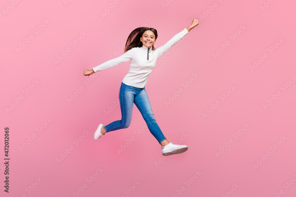 Full length profile photo of pretty brunette school supergirl run wear sweater jeans shoes isolated on pink color background