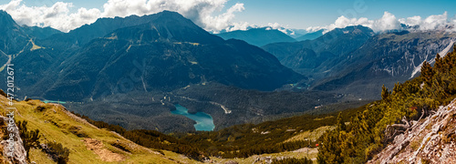 High resolution stitched panorama of a beautiful alpine summer view with the emerald green Blindsee lake seen from the famous Grubigstein summit near Lermoos, Tyrol, Austria photo