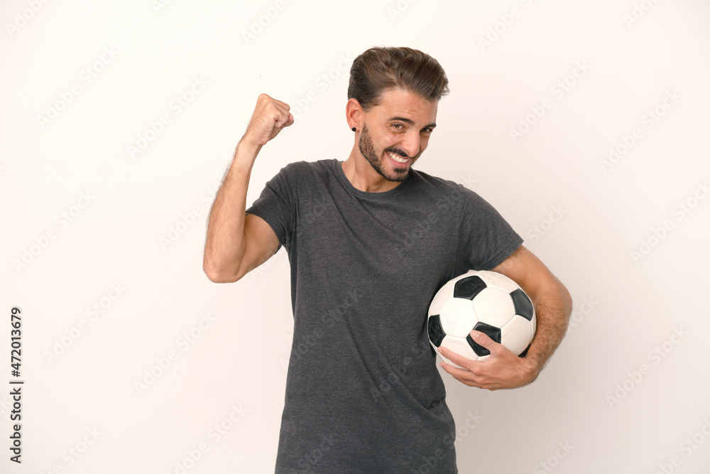 Young football player woman isolated on white background celebrating a victory