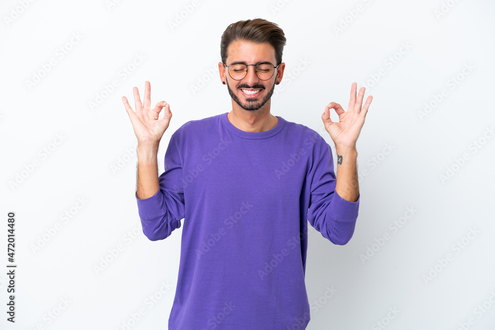Young caucasian man isolated on white background in zen pose Young caucasian man isolated on white background in zen pose