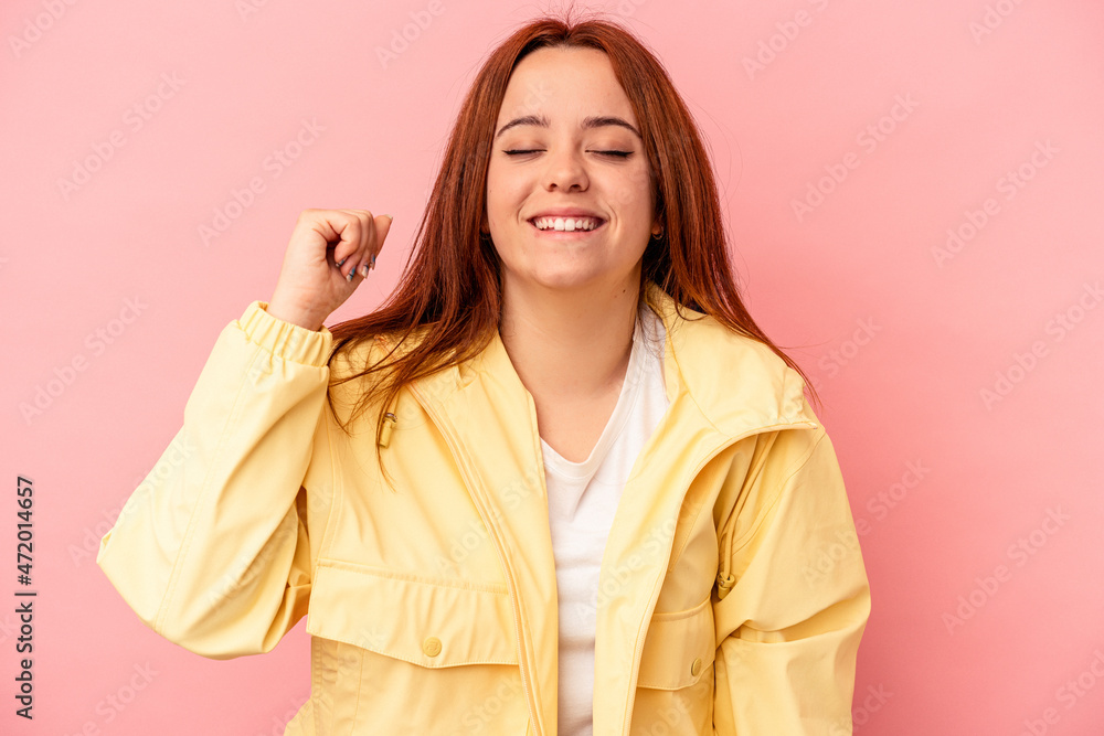 Young caucasian woman isolated on pink background celebrating a victory, passion and enthusiasm, happy expression. Young caucasian woman isolated on pink background celebrating a victory, passion and enthusiasm, happy expression.