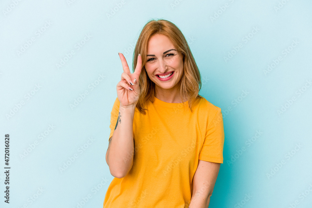 Young caucasian woman isolated on blue background showing number two with fingers. Young caucasian woman isolated on blue background showing number two with fingers.