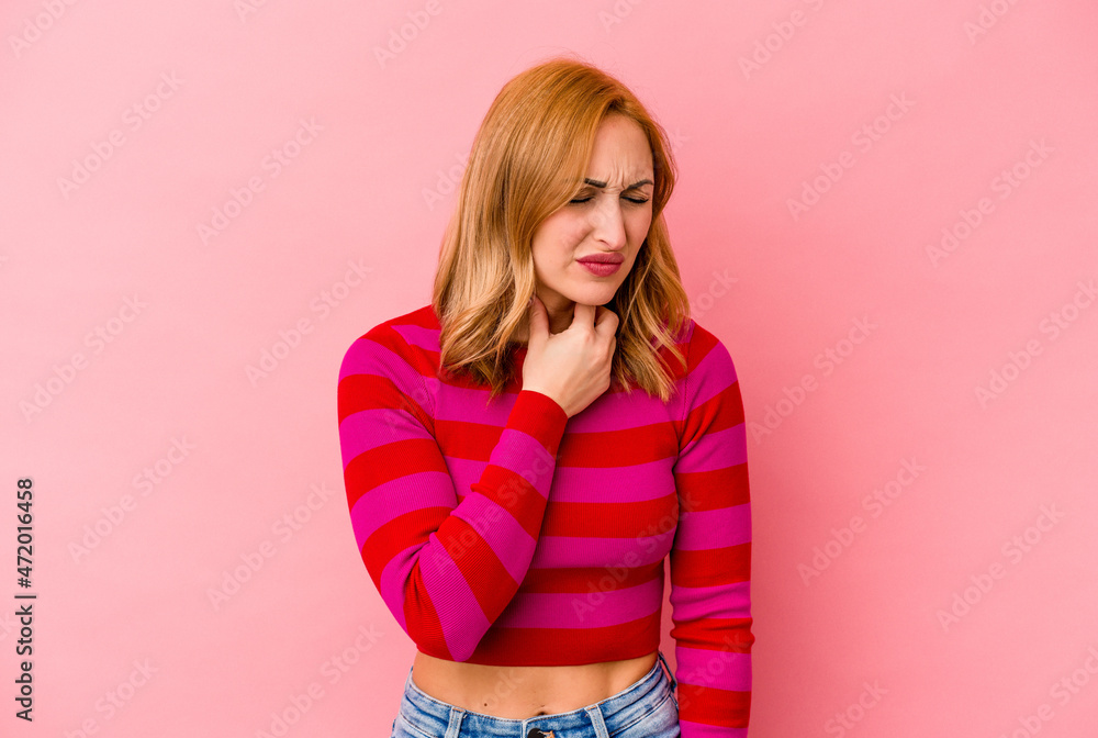Young caucasian woman isolated on pink background suffers pain in throat due a virus or infection. Young caucasian woman isolated on pink background suffers pain in throat due a virus or infection.