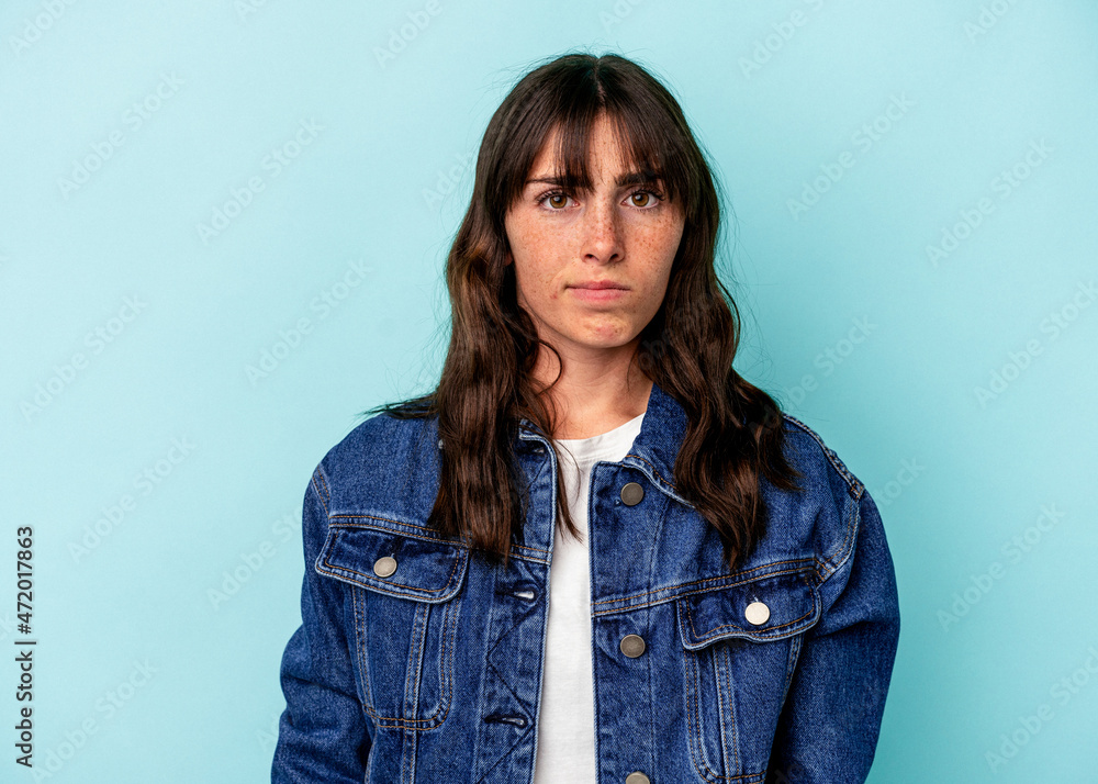 Young Argentinian woman isolated on blue background sad, serious face, feeling miserable and displeased. Young Argentinian woman isolated on blue background sad, serious face, feeling miserable and displeased.