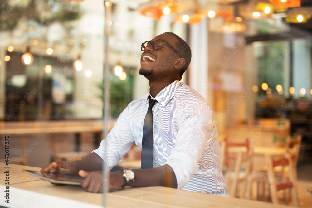 Businessman drinking coffee in cafe. Handsome African man enjoying in fresh coffee.. Businessman drinking coffee in cafe. Handsome African man enjoying in fresh coffee..