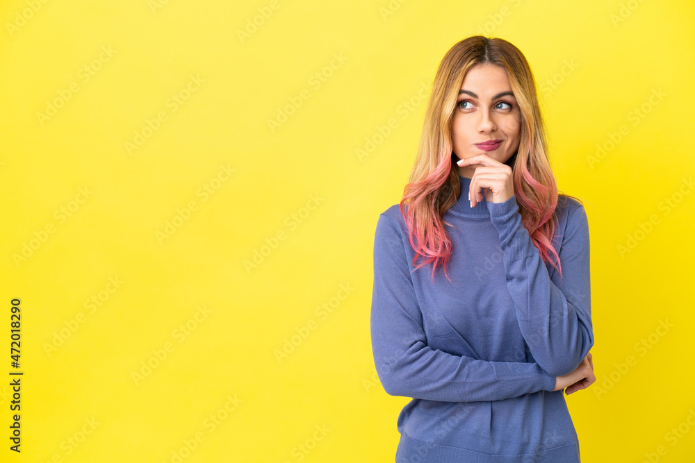 Young woman over isolated yellow background having doubts and thinking Young woman over isolated yellow background having doubts and thinking