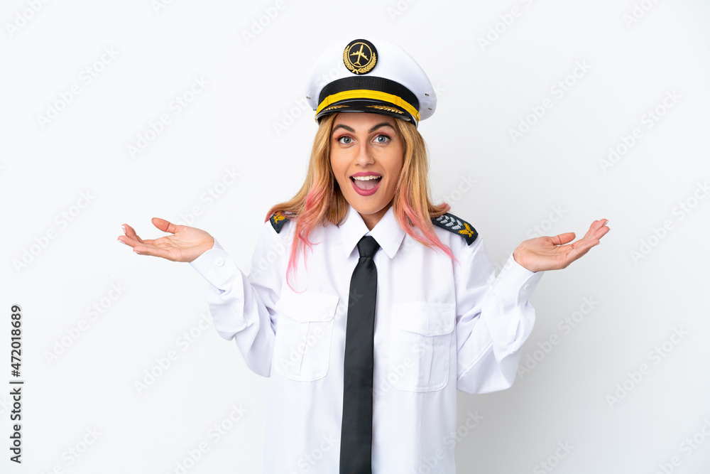 Airplane pilot over isolated white background with shocked facial expression Airplane pilot over isolated white background with shocked facial expression