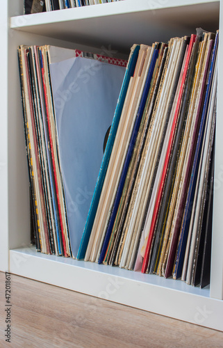 Stack of vintage vinyl discs in sleeves. Pile of secondhand classic vinyl. Music nostalgia. DJ vinyl collection. Retro songs. Vintade audio and stereo.  Old fashioned music. photo