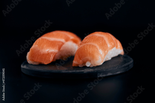 sushi on a black plate