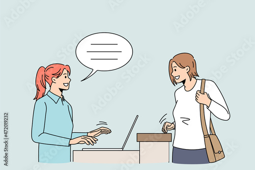 Smiling female client talk with caring receptionist in hotel ask advice or help. Happy woman customer speak with administrator working on computer sitting at desk. Good service. Vector illustration. 