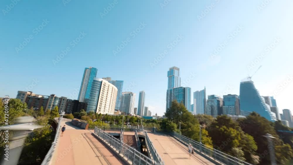 Aerial Fpv drone fly through of downtown Austin, Texas Lamar pedestrian bridge through park and downtown buildings skyline 4k Aerial Fpv drone fly through of downtown Austin, Texas Lamar pedestrian bridge through park and downtown buildings skyline 4k