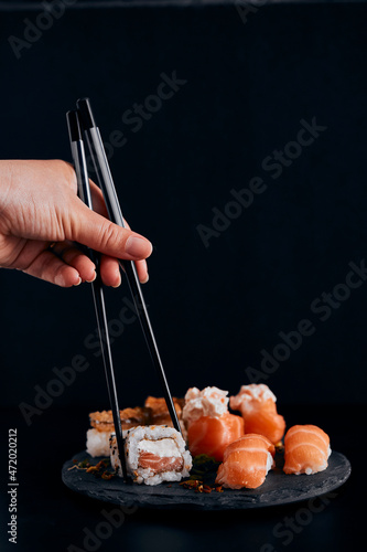 sushi on a plate black background