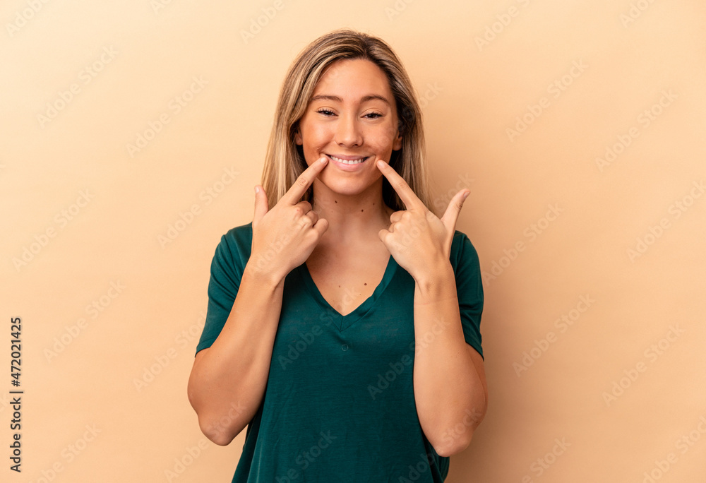 Young caucasian woman isolated on beige background doubting between two options. Young caucasian woman isolated on beige background doubting between two options.
