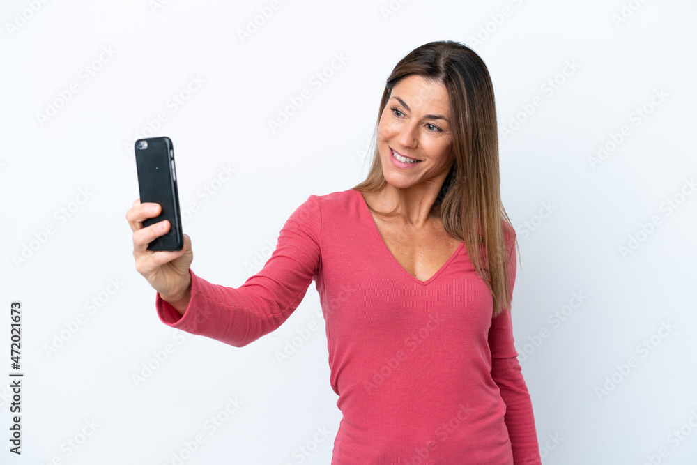 Middle age caucasian woman isolated on white background making a selfie