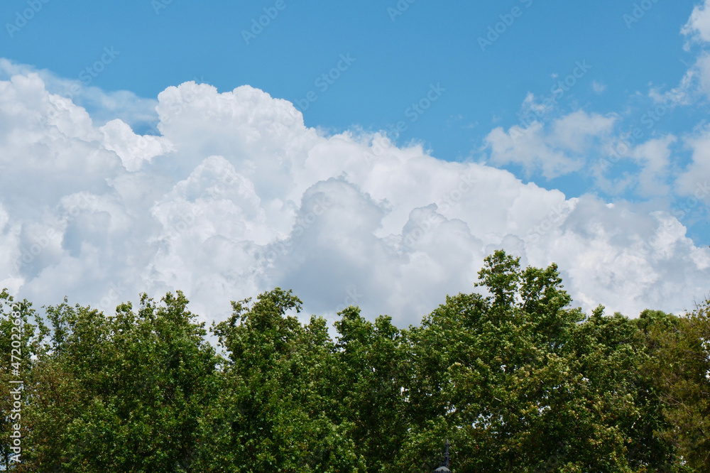 Dramatic cloudscape over green trees in Madrid, Spain