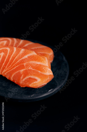 various salmon sushi on a black plate