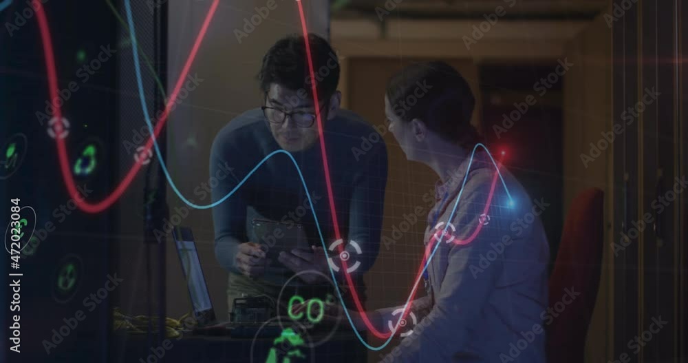 Animation of data processing, diverse male and female it engineers with laptop by computer servers Animation of data processing, diverse male and female it engineers with laptop by computer servers